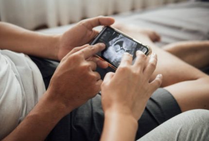 looking at baby images on phone